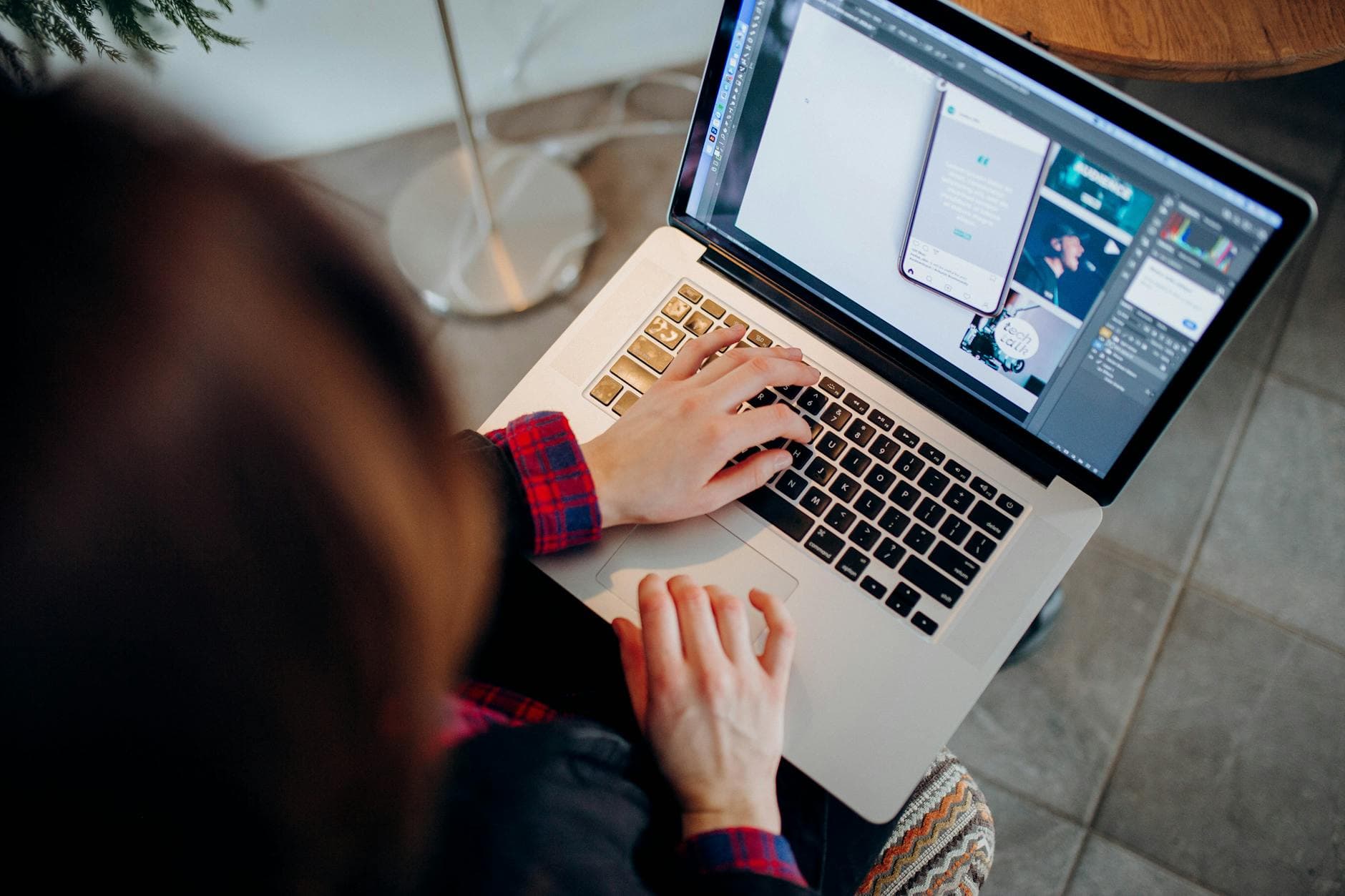 A person using a laptop with AI-generated graphics and text appearing on screen, symbolizing AI freelancing.